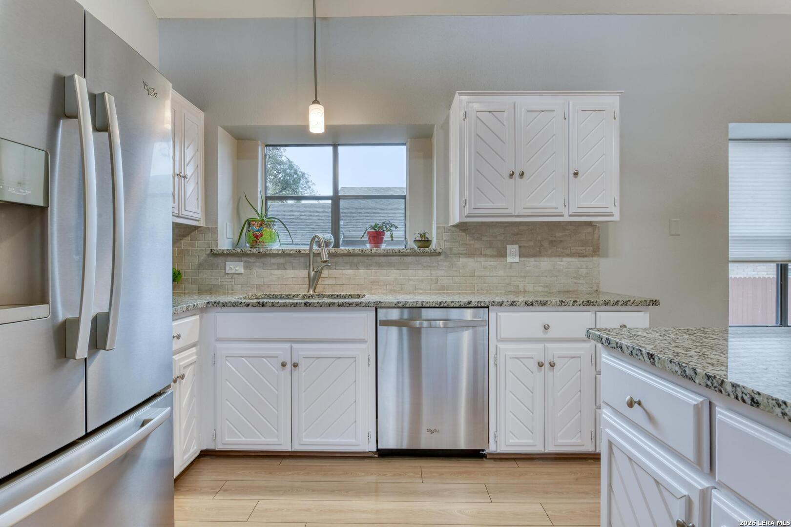 3154 Morning Trail San Antonio, TX 78247 - Photo 9 of 41 a kitchen with granite countertop a sink stainless steel appliances and cabinets