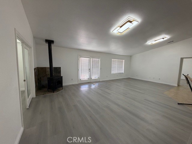 4679 Gorgonio Road Phelan, CA 92371 - Photo 11 of 17 a view of an empty room with wooden floor and windows