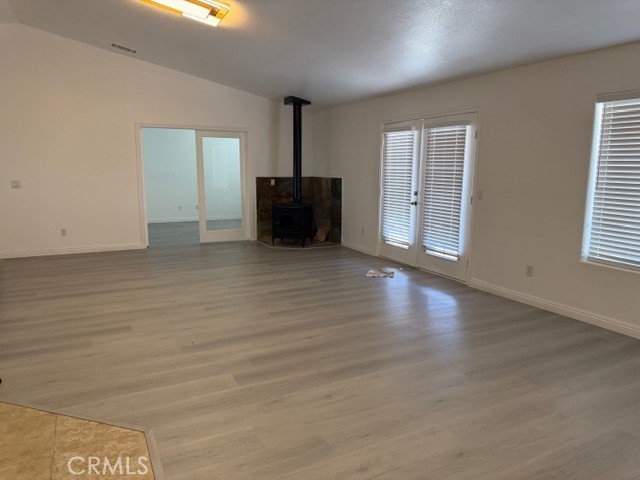 4679 Gorgonio Road Phelan, CA 92371 - Photo 12 of 17 a view of an empty room with wooden floor and a window