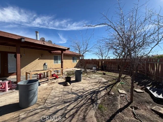 a view of a backyard with sitting area