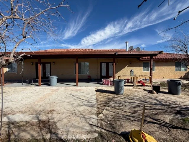 a view of a house with backyard porch and sitting area