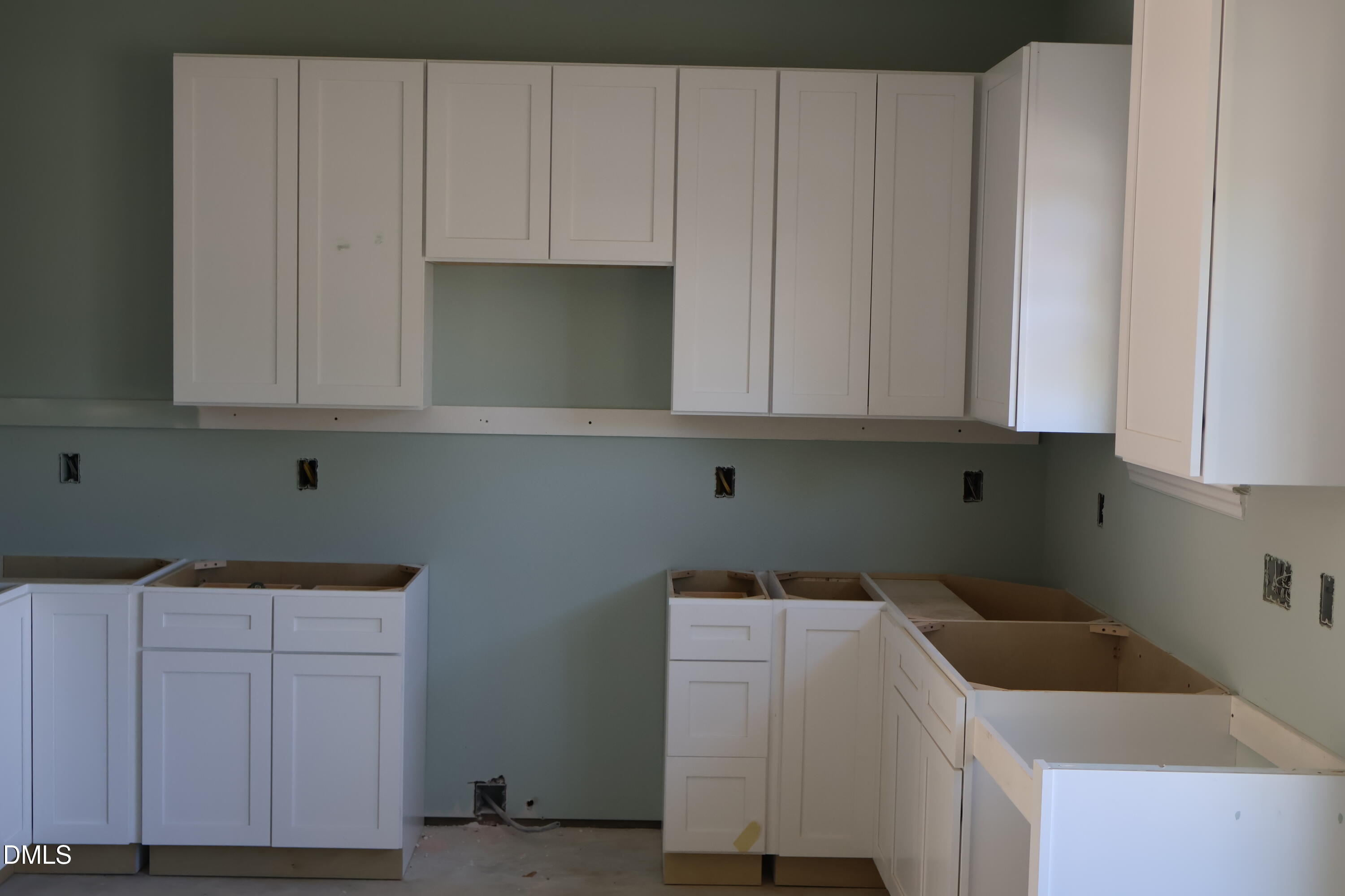 117 Wilson Street Erwin, NC 28339 - Photo 9 of 15 a utility room with wooden floor and cabinets