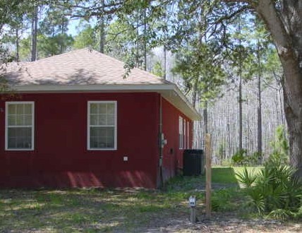 4555 Carter Road St. Augustine, FL 32086 - Photo 2 of 14 a front view of a house with garden