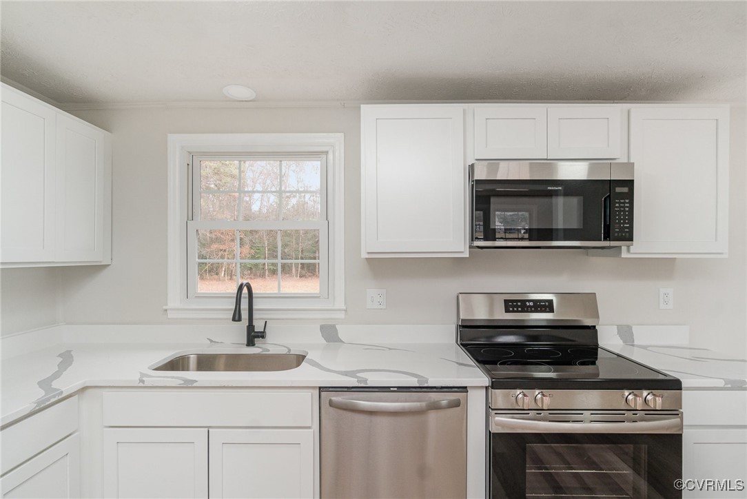19256 Perimeter Road Milford, VA 22514 - Photo 12 of 29 Kitchen featuring white cabinetry, sink, and appli