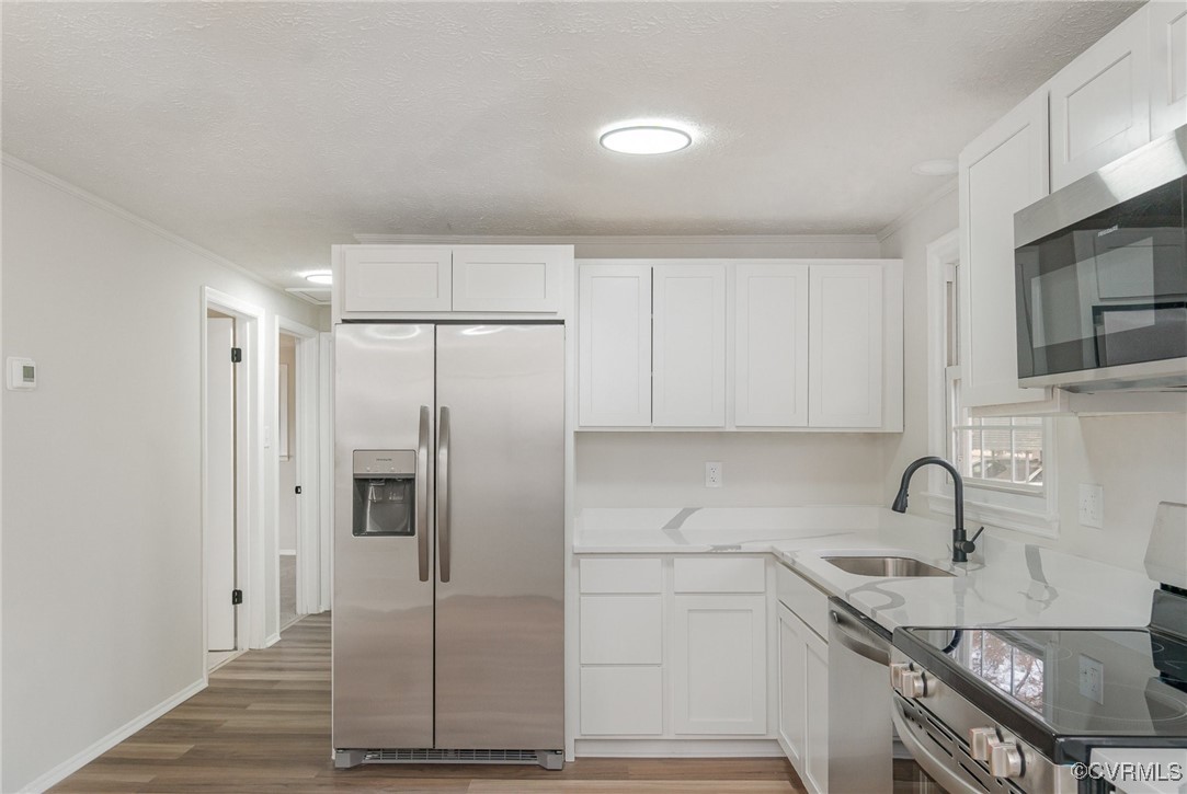19256 Perimeter Road Milford, VA 22514 - Photo 13 of 29 Kitchen with white cabinets, sink, stainless steel