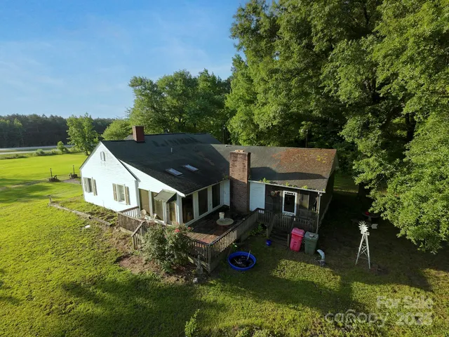 an aerial view of a house with swimming pool and garden