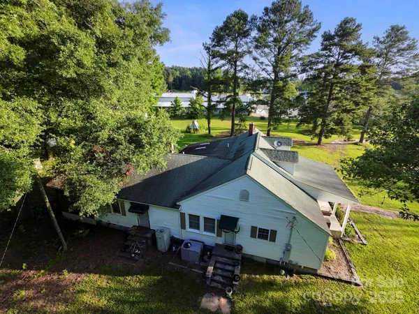 an aerial view of a house with swimming pool garden and patio