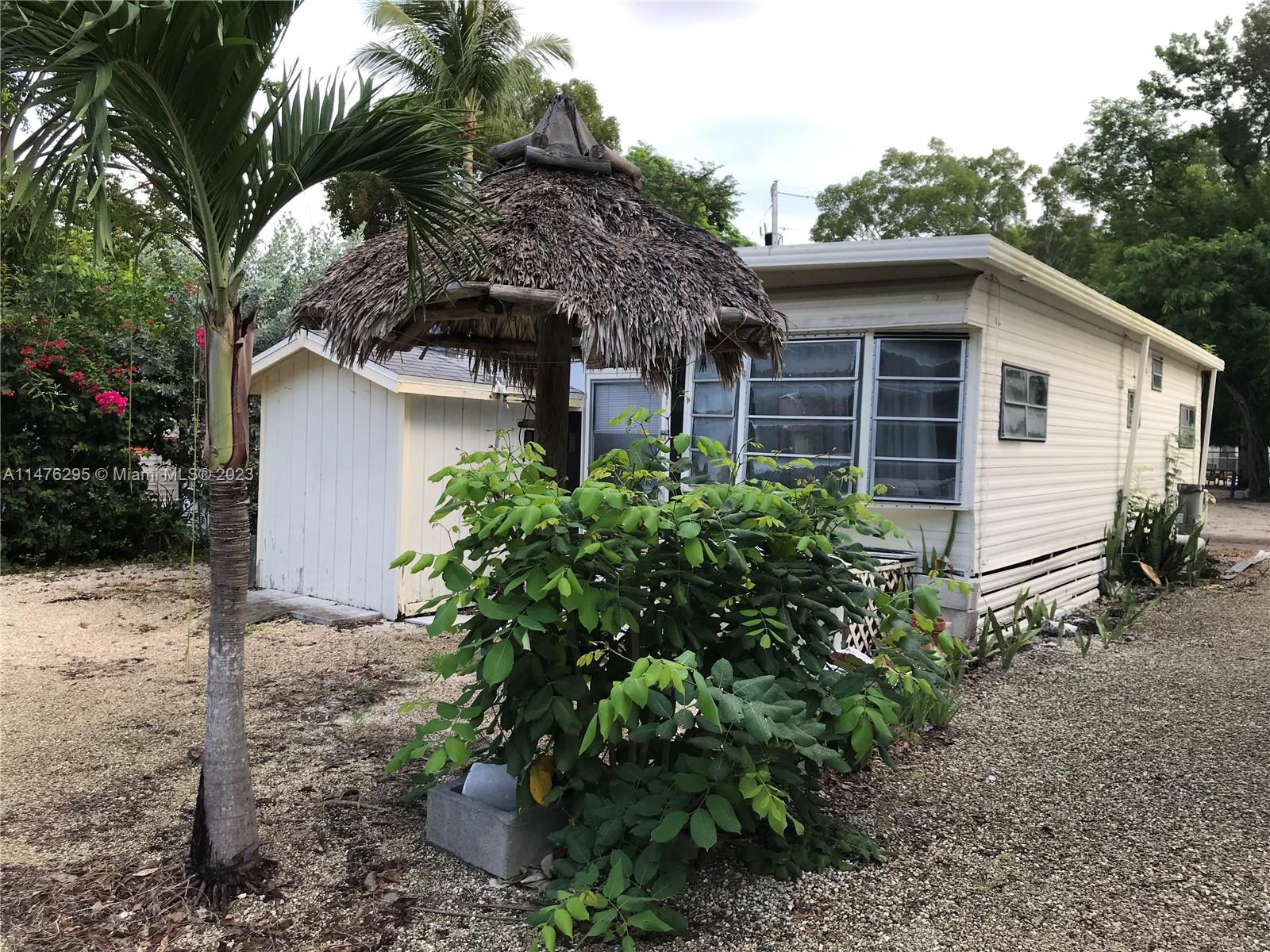Key Largo Key Largo, FL 33037 - Photo 1 of 18 a house is sitting in middle of the garden