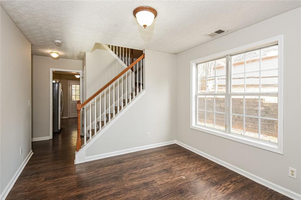 3328 River Run Trail Decatur, GA 30034 - Photo 7 of 20 a view of an empty room with wooden floor and a window