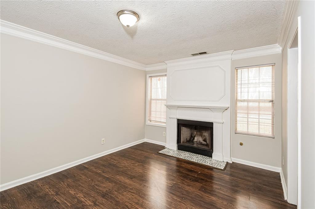 3328 River Run Trail Decatur, GA 30034 - Photo 8 of 20 an empty room with wooden floor fireplace and windows