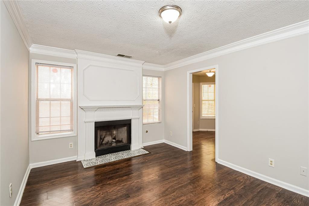 3328 River Run Trail Decatur, GA 30034 - Photo 9 of 20 an empty room with wooden floor fireplace and windows