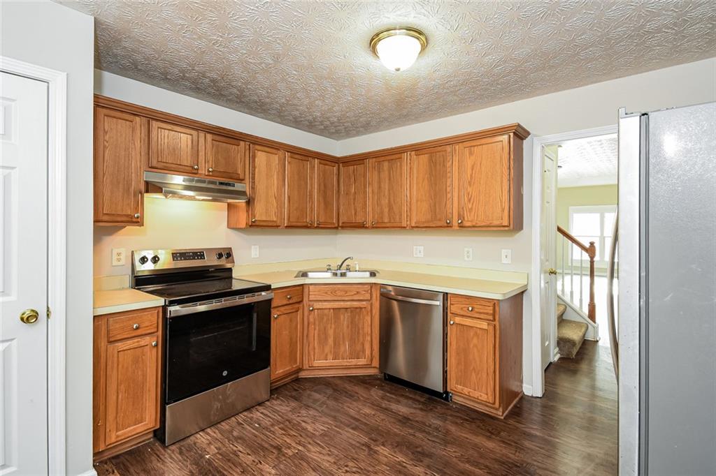 3328 River Run Trail Decatur, GA 30034 - Photo 10 of 20 a kitchen with stainless steel appliances granite countertop a stove and a sink