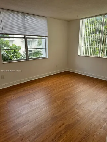 a kitchen with wooden cabinets and a stove top oven