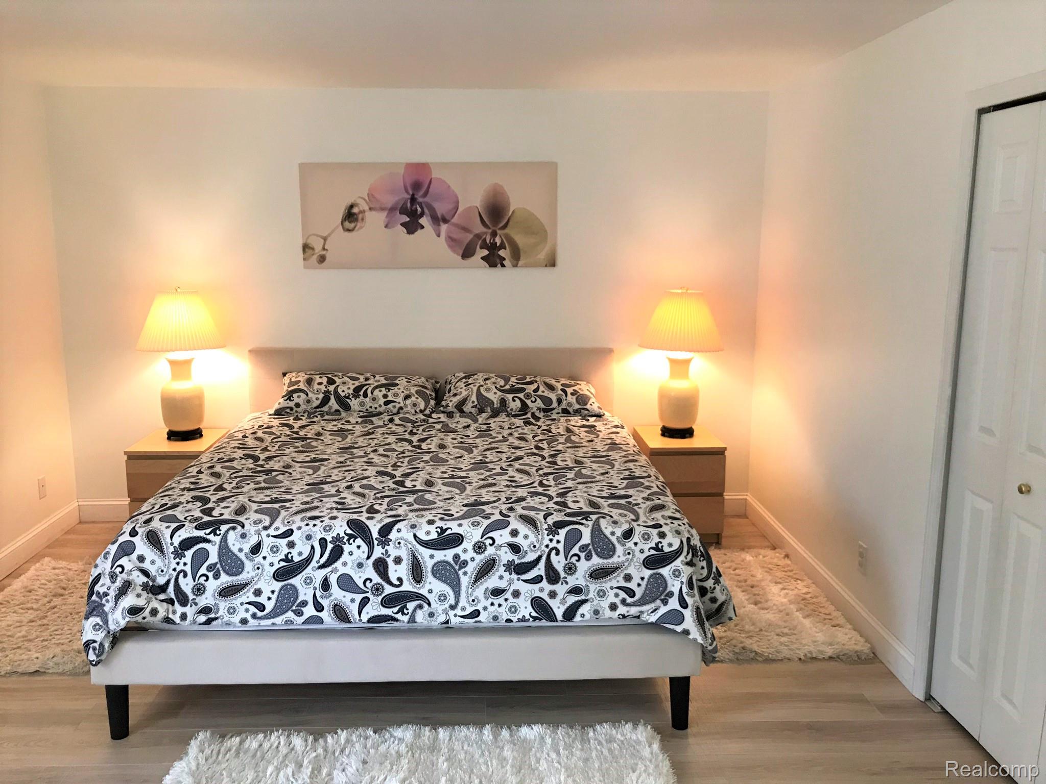 3633 Oakmonte Boulevard, Unit 189 Rochester, MI 48306 - Photo 31 of 36 Furnished Primary Bedroom featuring light luxury laminate floors and a closet