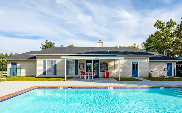 a view of a house with swimming pool and a yard