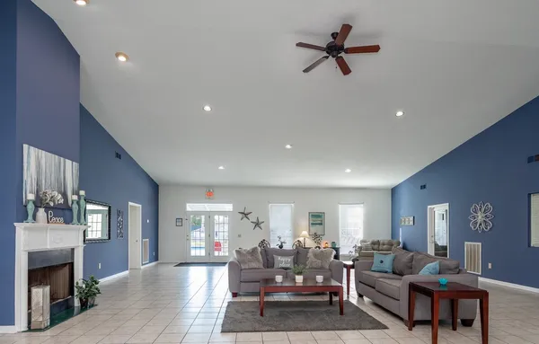 a living room with furniture ceiling fan and a rug