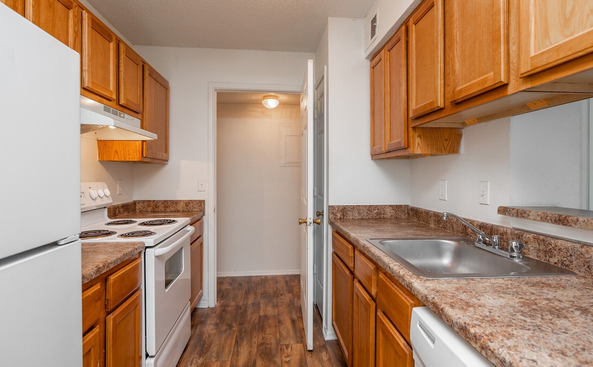 100 Remington Drive Dickson, TN 37055 - Photo 7 of 11 a kitchen with granite countertop a sink a stove and cabinets