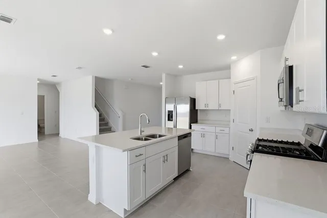 a kitchen with a sink stove and cabinets