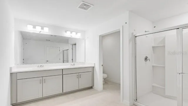 a kitchen with appliances a sink and cabinets