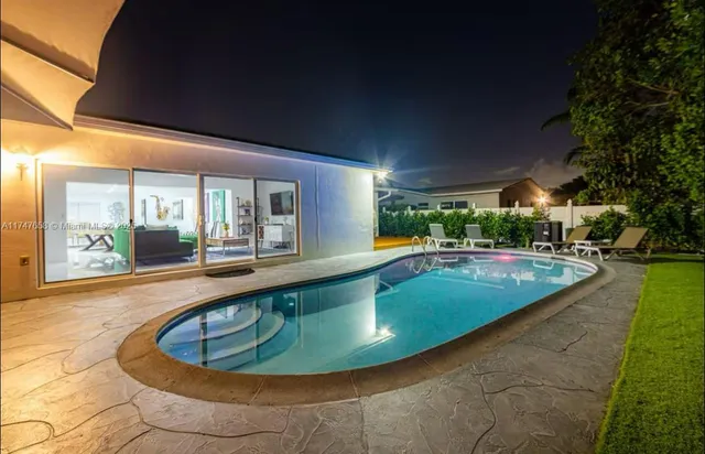 a view of a swimming pool with an outdoor seating