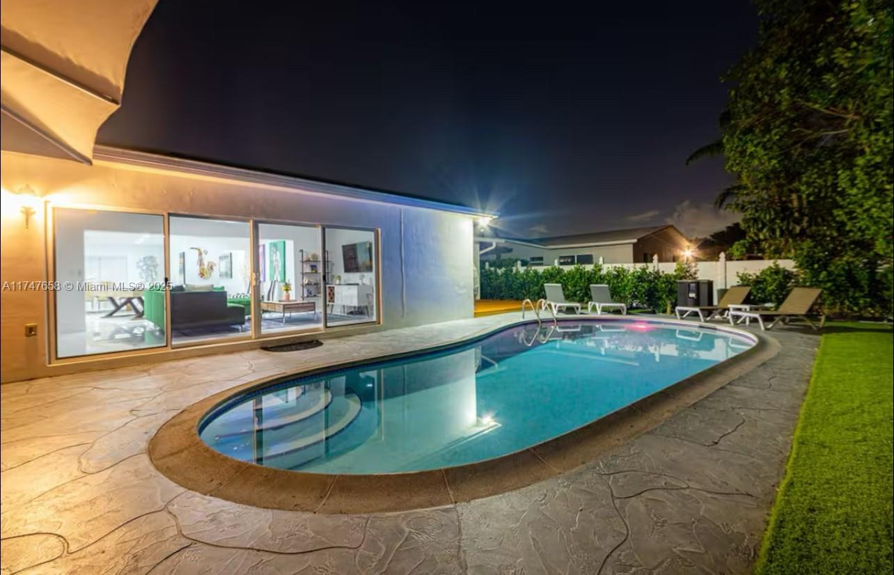 a view of a swimming pool with an outdoor seating