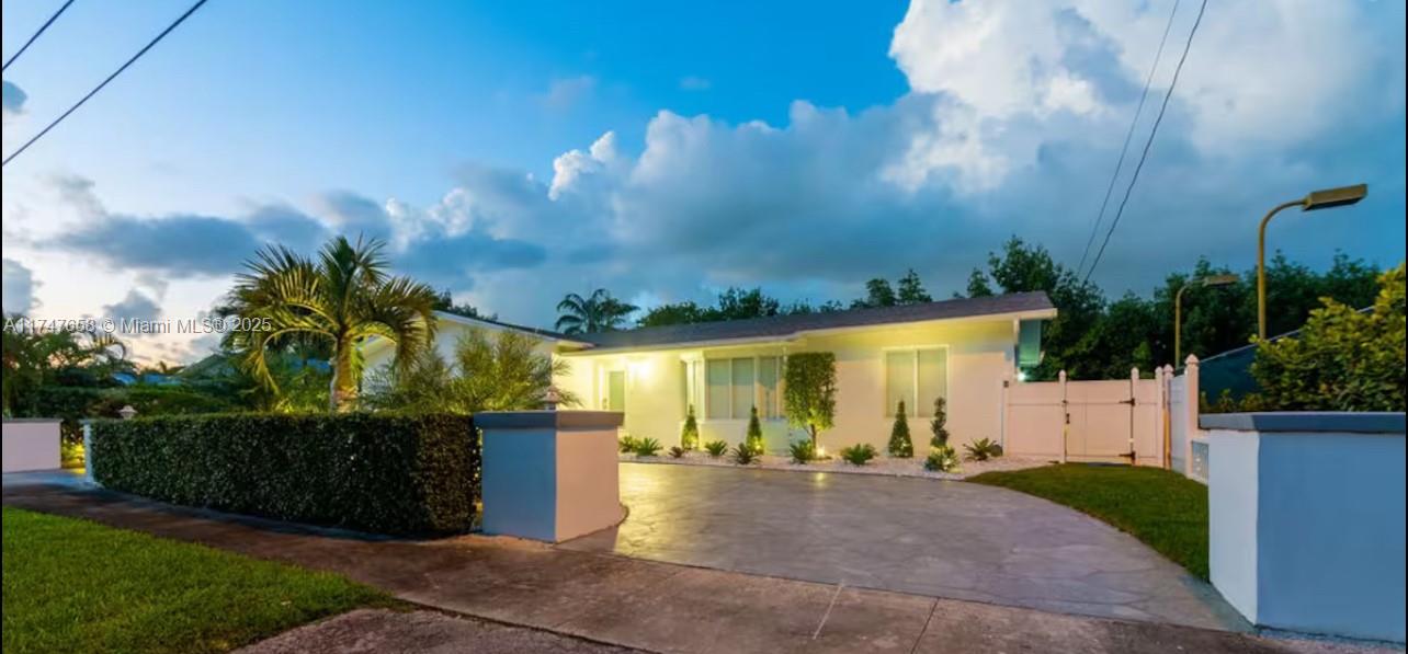2271 Northeast 191st Street Miami, FL 33180 - Photo 11 of 24 a view of a house with backyard and a garden