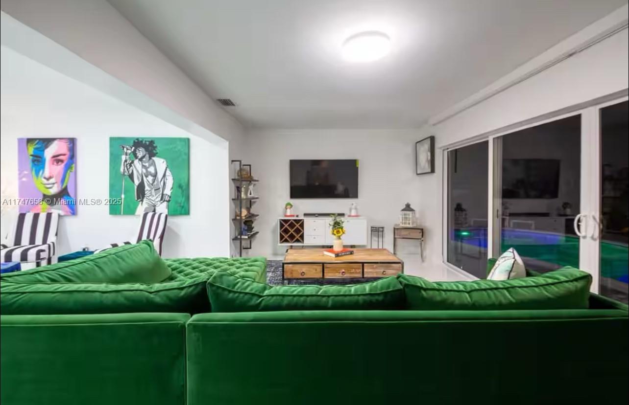 2271 Northeast 191st Street Miami, FL 33180 - Photo 12 of 24 a living room with furniture a flat screen tv and a fireplace