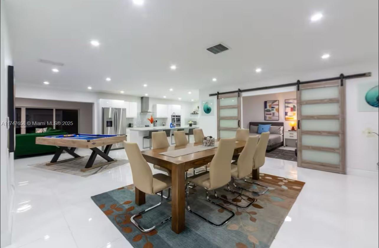 2271 Northeast 191st Street Miami, FL 33180 - Photo 15 of 24 a living room with furniture a table and kitchen view