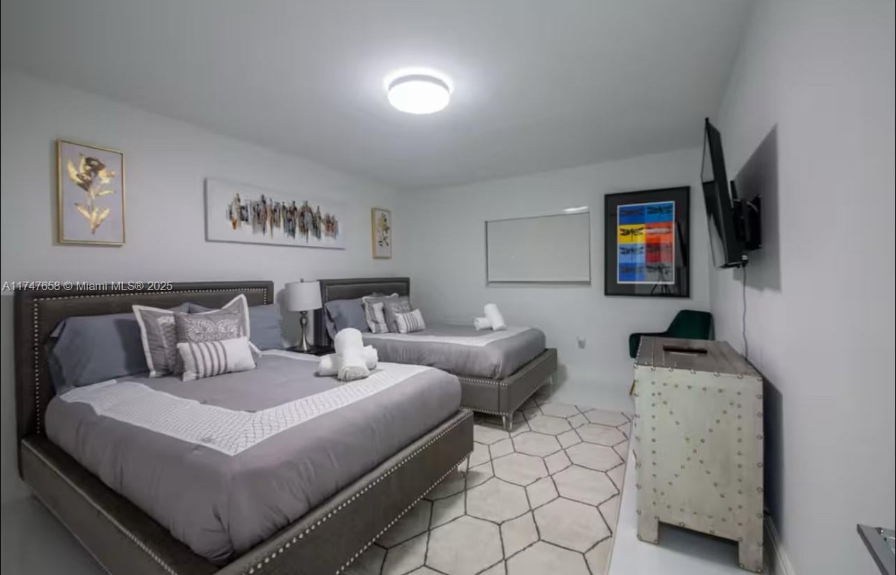 2271 Northeast 191st Street Miami, FL 33180 - Photo 20 of 24 a bedroom with bed and a couch