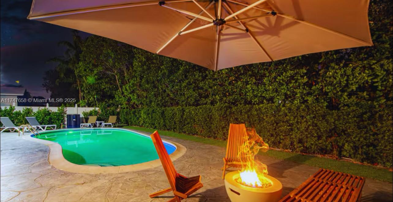 2271 Northeast 191st Street Miami, FL 33180 - Photo 2 of 24 a view of a backyard with swimming pool and sitting area