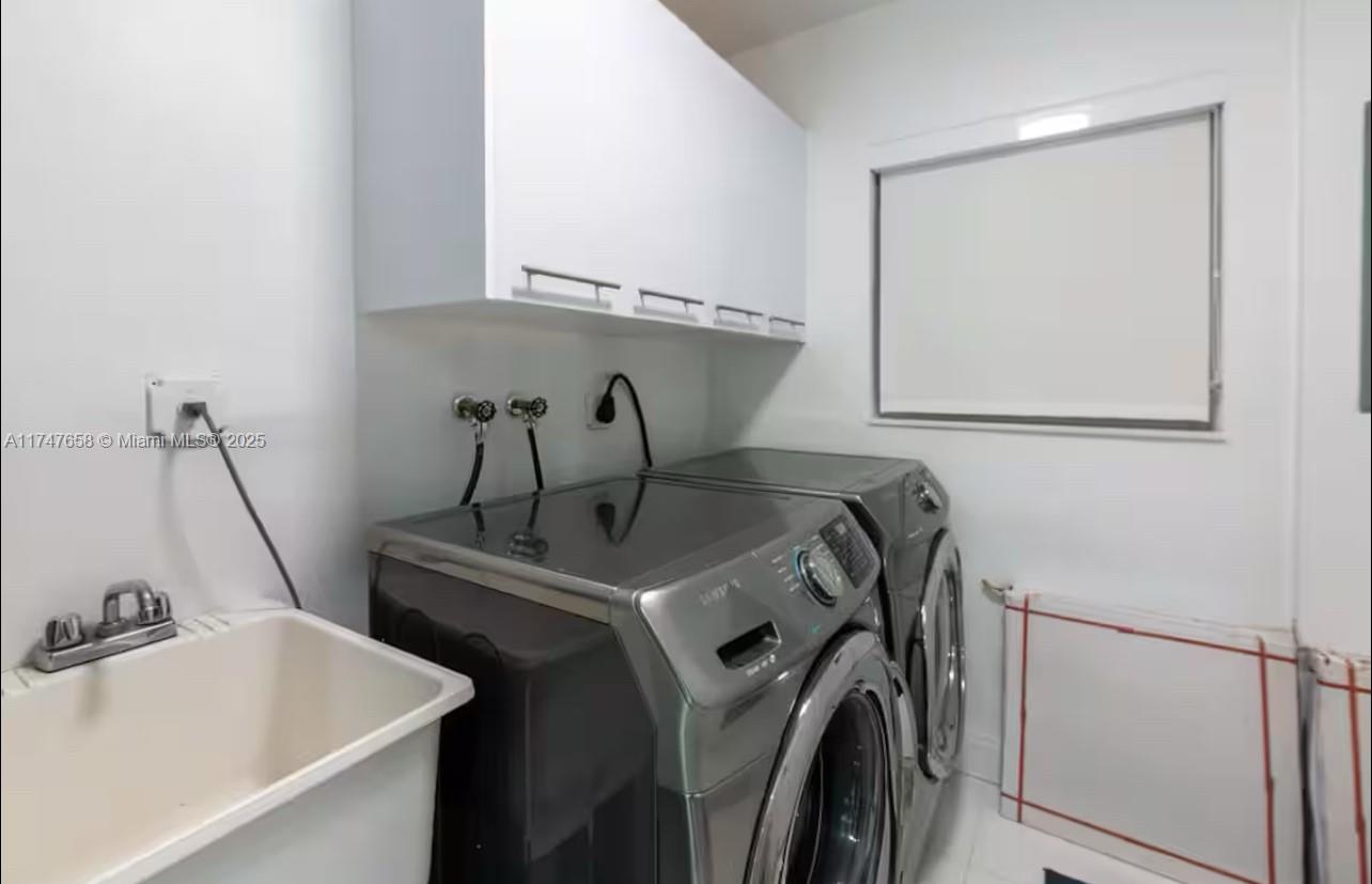 2271 Northeast 191st Street Miami, FL 33180 - Photo 23 of 24 a utility room with dryer and washer
