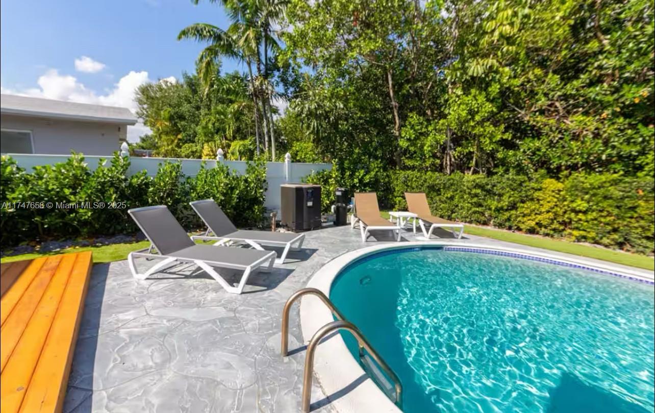 2271 Northeast 191st Street Miami, FL 33180 - Photo 5 of 24 a view of backyard with swimming pool and seating space