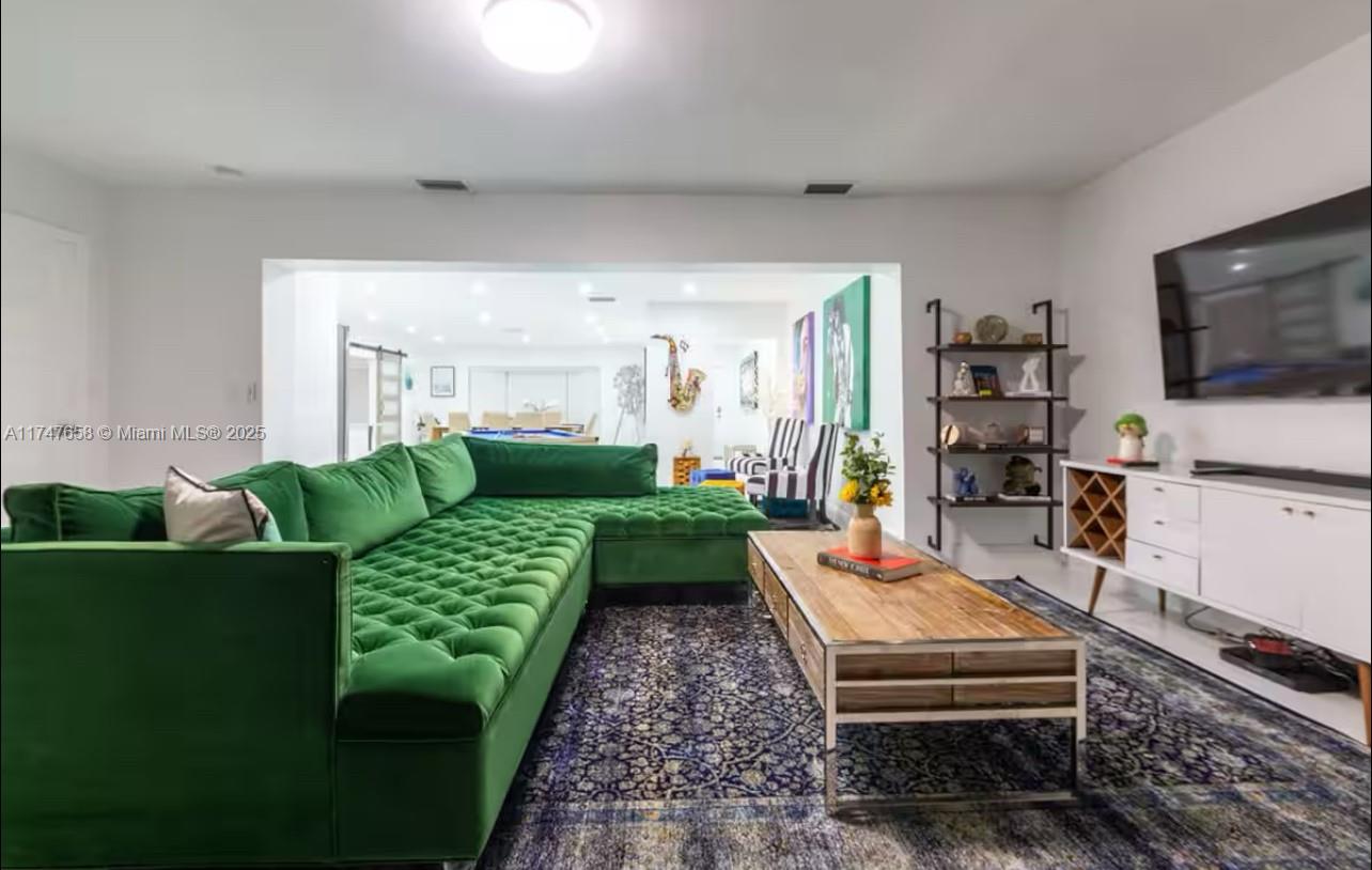 2271 Northeast 191st Street Miami, FL 33180 - Photo 8 of 24 a living room with furniture and a flat screen tv