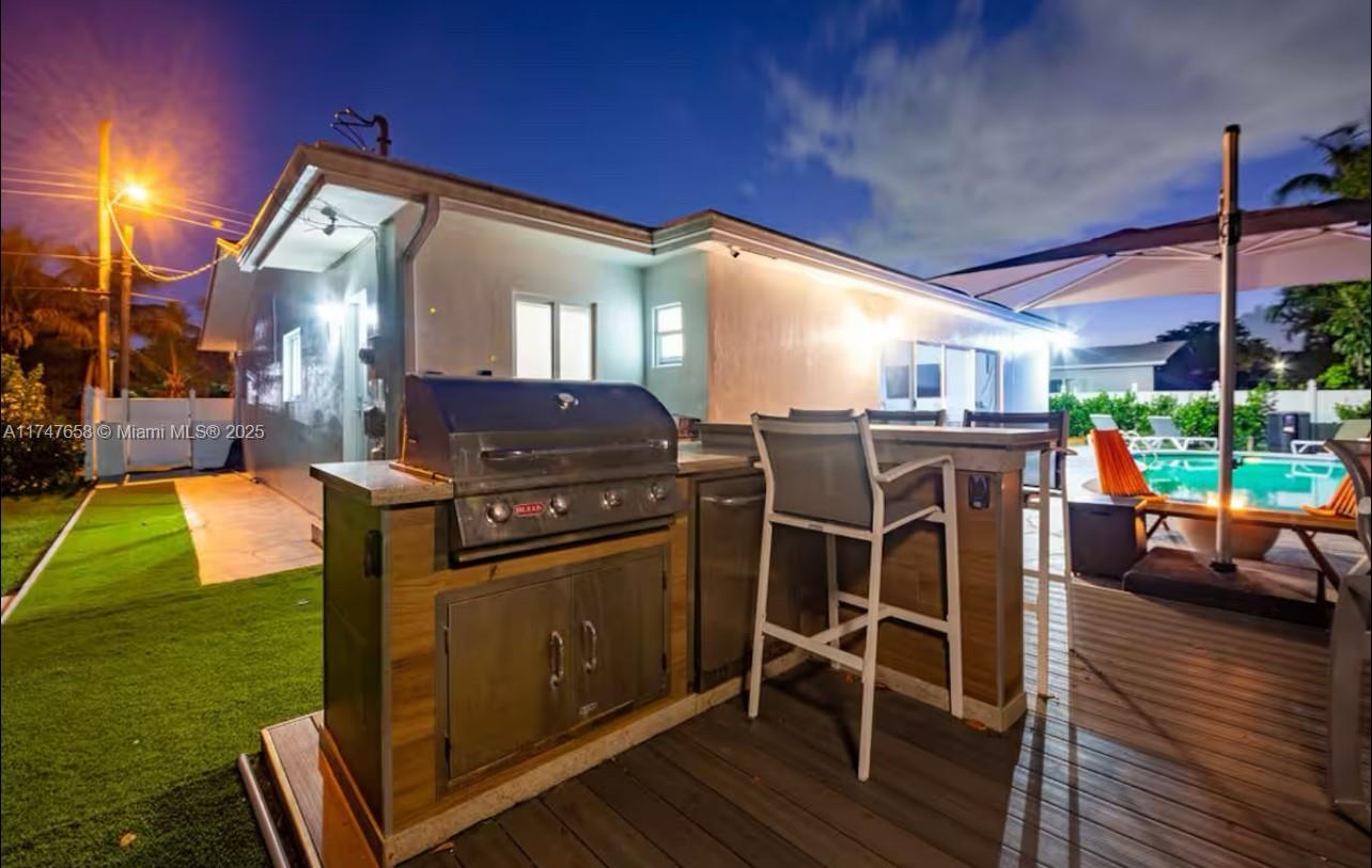 2271 Northeast 191st Street Miami, FL 33180 - Photo 10 of 24 a kitchen with stainless steel appliances granite countertop a stove a sink dishwasher and a microwave oven with cabinets