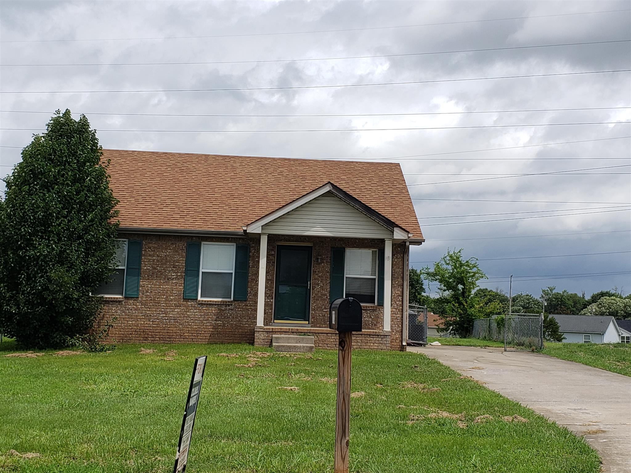 113 Waterford Drive Oak Grove, KY 42262 - Photo 1 of 13 a front view of a house with a yard and garage