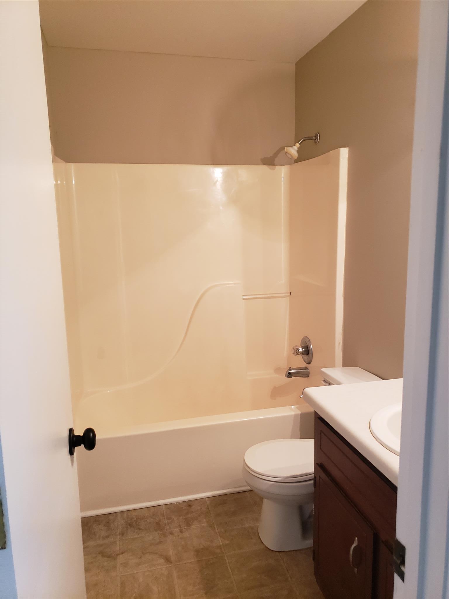 113 Waterford Drive Oak Grove, KY 42262 - Photo 13 of 13 a bathroom with a granite countertop bathtub shower sink vanity and toilet