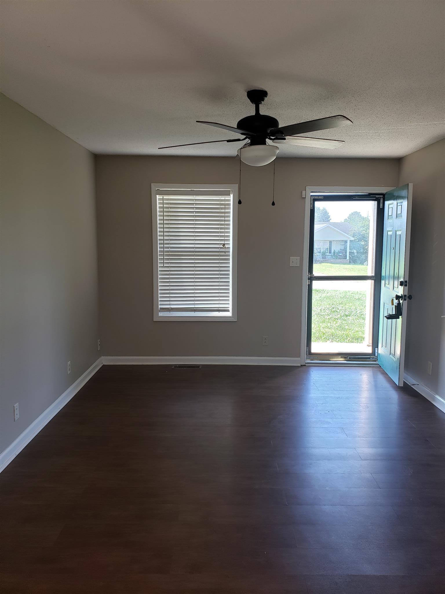 113 Waterford Drive Oak Grove, KY 42262 - Photo 6 of 13 a view of an empty room with wooden floor and a window