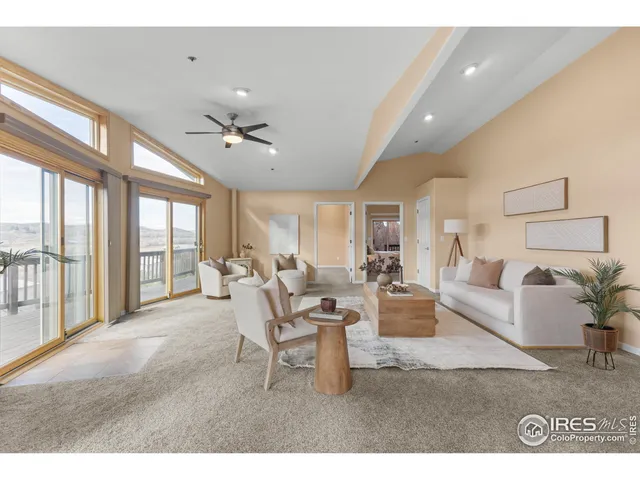 a living room with furniture and large windows