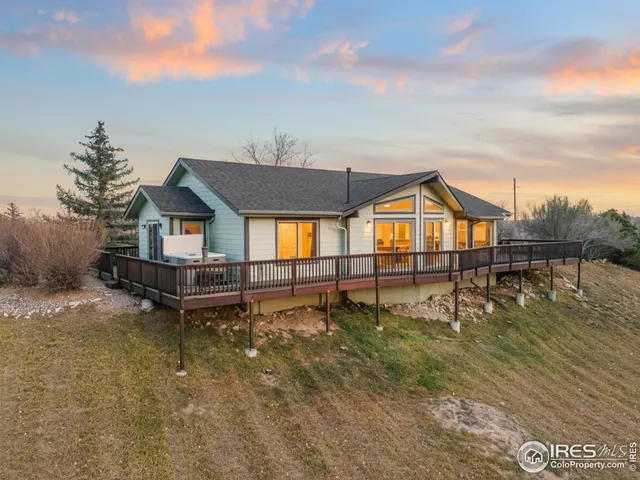 a view of a house with pool and sitting area