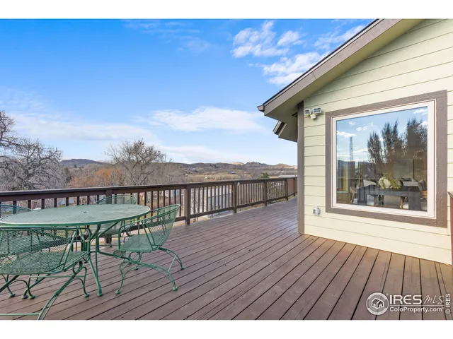 a view of balcony with wooden floor and outdoor seating