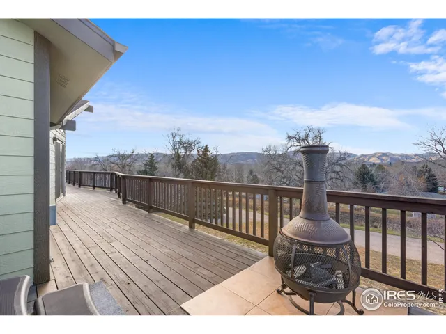 a view of a balcony with wooden floor and bench