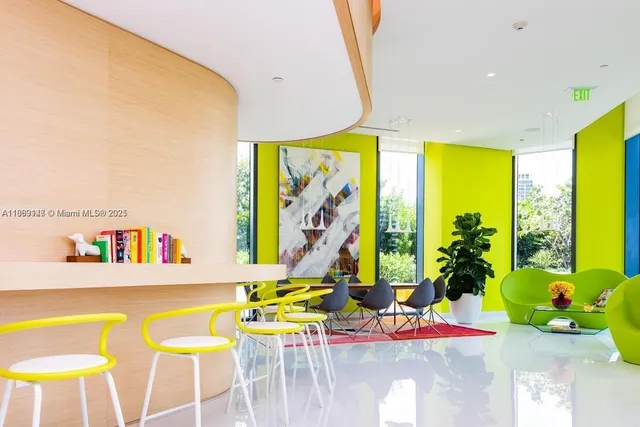 a dining room with furniture and a large window