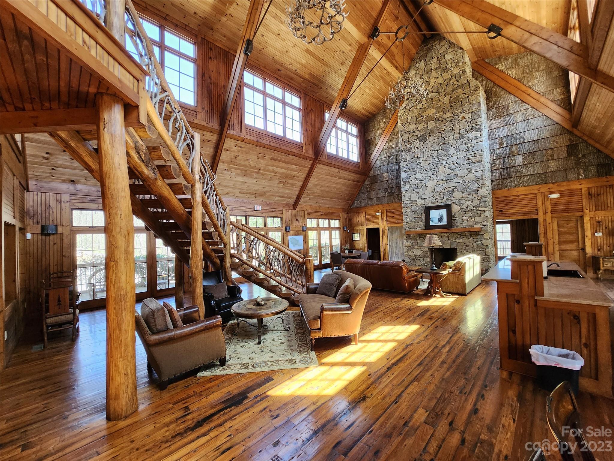 435 Pine Cone Trail Marshall, NC 28753 - Photo 21 of 34 a view of a patio with couches fire pit and wooden floor
