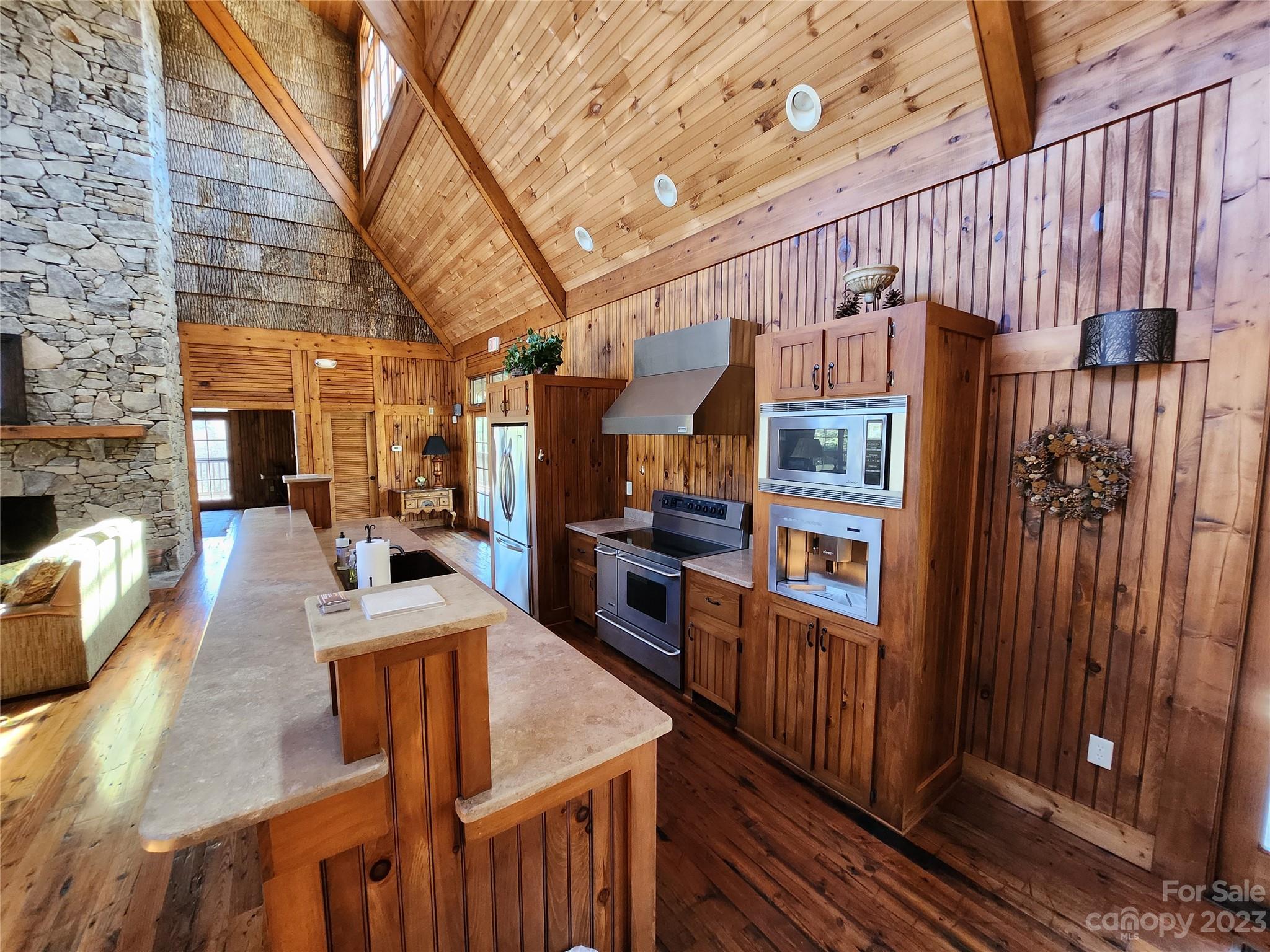 435 Pine Cone Trail Marshall, NC 28753 - Photo 22 of 34 a view of a living room kitchen and a wooden floor