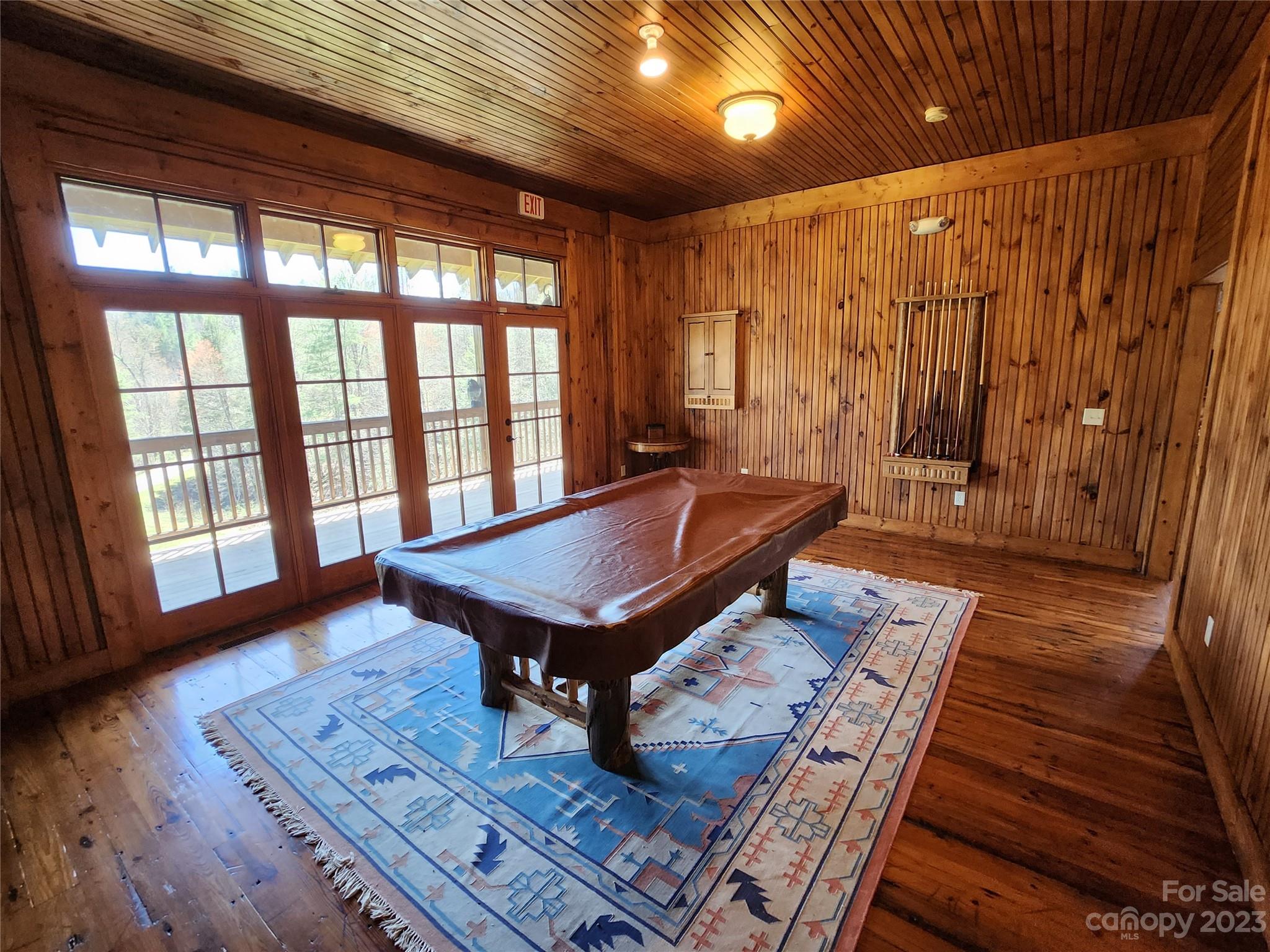 435 Pine Cone Trail Marshall, NC 28753 - Photo 23 of 34 a living room with furniture a table and wooden floor