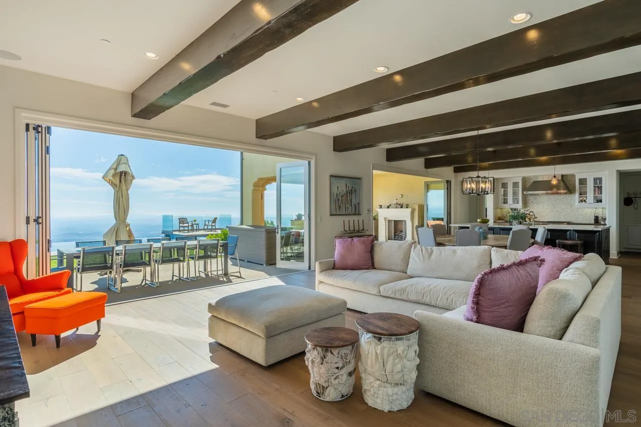 8749 Via Rancho Cielo Rancho Santa Fe, CA 92067 - Photo 7 of 30 a living room with furniture and a floor to ceiling window