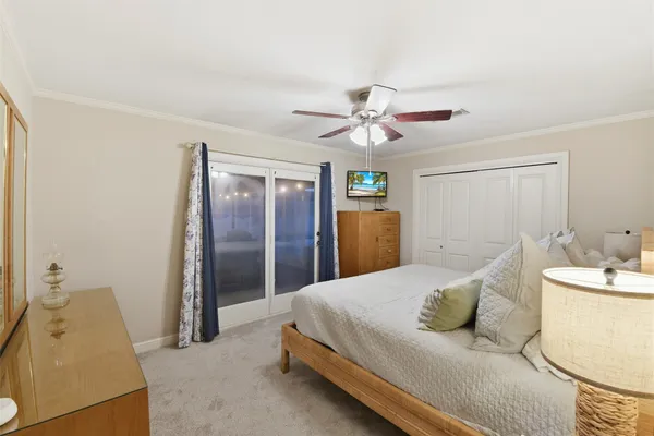 a spacious bedroom with a bed and a chandelier