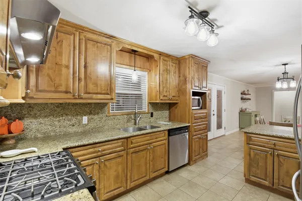 a kitchen with stainless steel appliances granite countertop a sink and cabinets