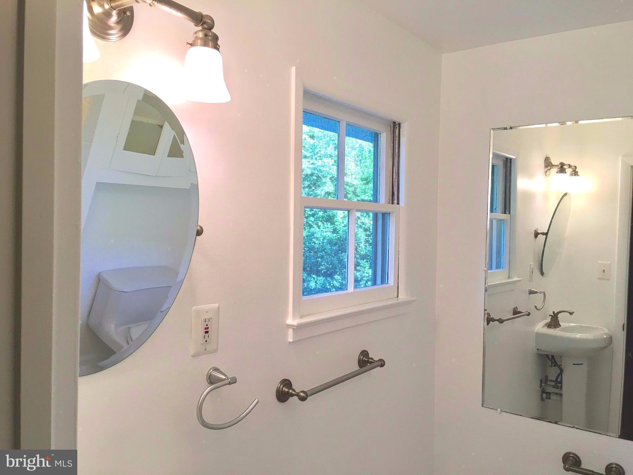 1003 Dead Run Drive McLean, VA 22101 - Photo 11 of 26 a bathroom with a sink mirror and toilet