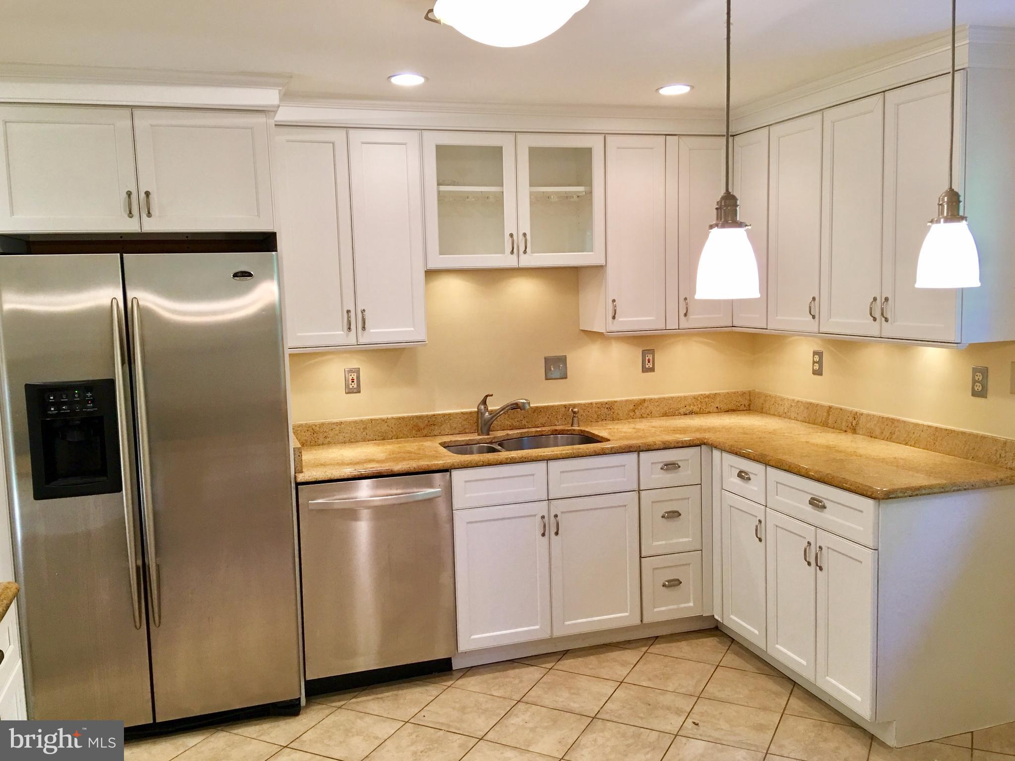 1003 Dead Run Drive McLean, VA 22101 - Photo 2 of 26 a kitchen with granite countertop a sink stainless steel appliances and cabinets